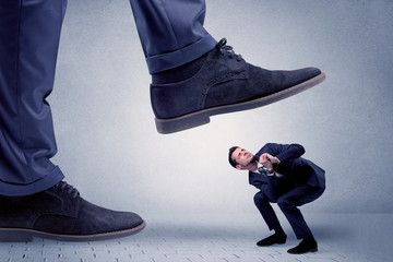 Young businessman getting crushed