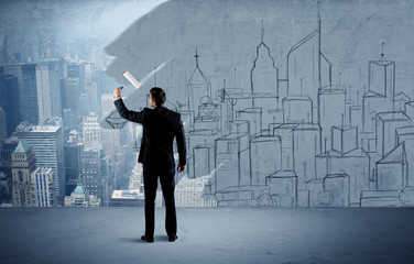 Elegant salesman repainting the city on wall