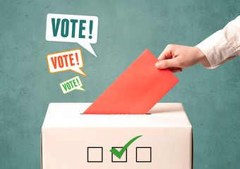 placing a voting slip into a ballot box