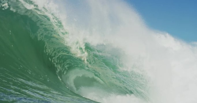 Big Blue Ocean Wave Breaking in Slow Motion 4K in dangerous shallow water
