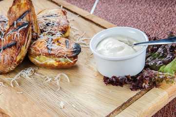 Baked potatoes with white cream sauce. Easy and healthy vegetarian food.