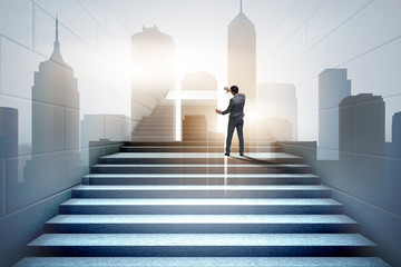 Businessman climbing up challenging career ladder in business co