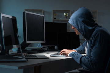 Hacker hacking computer at night