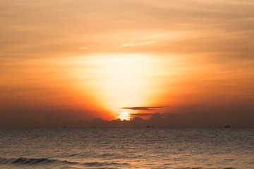 Naklejka na ściany i meble Sunset sunrise golden sky over the sea Thailand.
