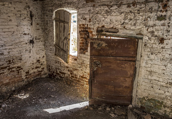 Inside an old dilapidated abandoned brick house.