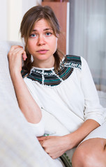 Portrait of miserable woman at home.
