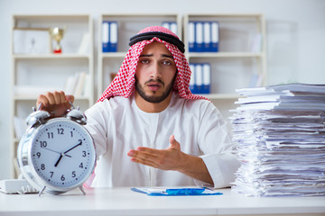 Arab businessman working in the office doing paperwork with a pi