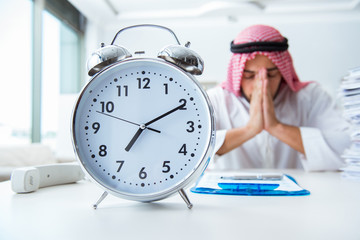 Arab businessman working in the office doing paperwork with a pi