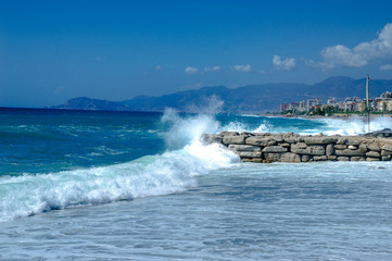 Waves break about a stone pier