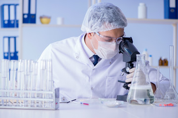 Man in the lab testing new cleaning solution detergent