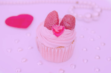 Delicious strawberry cupcakes with heart-shaped jelly are perfect for Valentine's Day backgrounds.