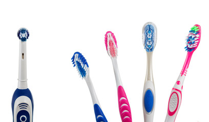 Four multi-colored manual toothbrushes and one electric, isolated on white background