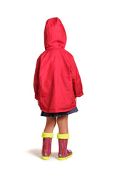 Girl is back in rubber boots and a raincoat isolated on white