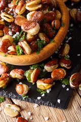 appetizer of crispy fried salted broad beans in a bowl close-up. vertical