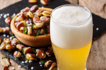 light beer and a snack of crispy fried salted beans close-up. horizontal