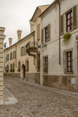 Fototapeta na wymiar old houses on cobbled street in city center, Mantua, Italy