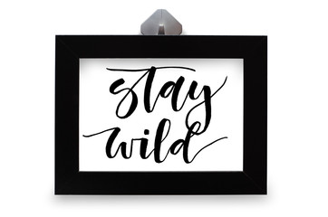 Stay wild. Handwritten text. Modern calligraphy. Inspirational quote. Black photo frame