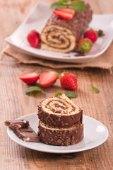 Chocolate roll with hazelnuts and strawberries. 