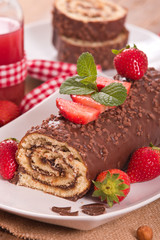 Chocolate roll with hazelnuts and strawberries. 