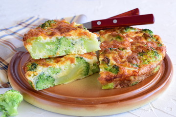 Broccoli pie on a brown ceramic plate. Healthy eating concept
