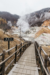 Wood structure walk way of Noboribetsu Jigokudani (Hell Valley): The volcano valley got its name from the sulfuric smell, extremely high heat and steam spouting out of the ground in Hokkaido, Japan.