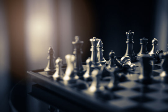 winning chess board game competition for successful company and strategy research business concept in blur image background of morning sun light
