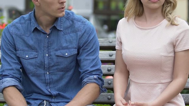 Angry blond girl giving a slap to her unfaithful boyfriend and walking away