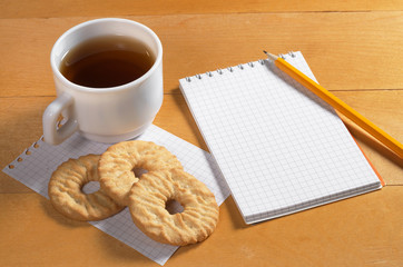 Notepad, tea and cookies