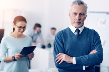 Serious mature man posing for camera at office