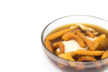 Soft bean curd in hot ginger syrup in transparent bowl