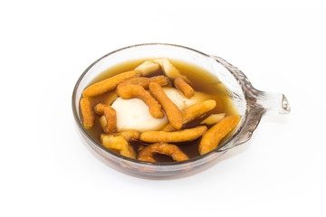 Soft bean curd in hot ginger syrup in transparent bowl