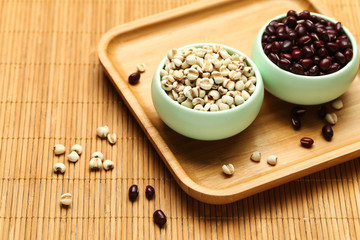 red beans and job’s tears in green bowl on bamboo