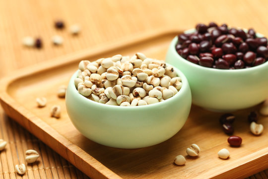 red beans and job&rsquo;s tears in green bowl on bamboo