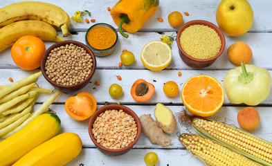 Yellow vegetables, beans and fruits - banana, corn, lemon, plum, apricot, pepper, zucchini, tomato, asparagus bean, millet, soybeans peas ginger Healthy food Top view Flat lay