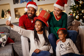 Mother making Christmas selfie with family together