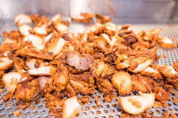 closeup Pile cooked fried pork in the market .