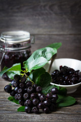 Homemade jam from black chokeberry and fresh berries chokeberry.