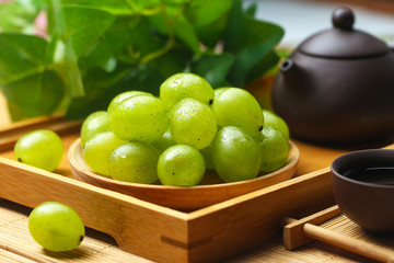 green grapes in wooden plate