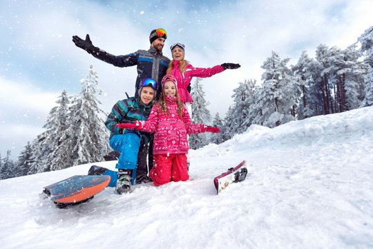family enjoying and having fun on winter vacation together on the mountain