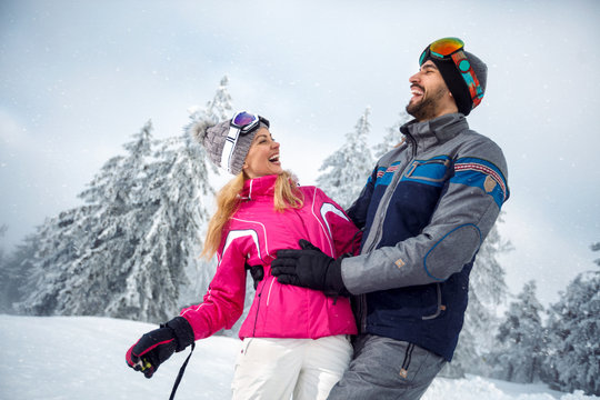 young couple having fun on winter vacation on the mountain