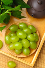 green grapes in wooden plate