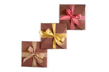 Christmas gifts wrapped in brown paper with the bow top view isolated on white background