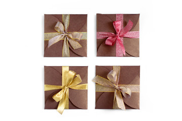Christmas gifts wrapped in brown paper with the bow top view isolated on white background