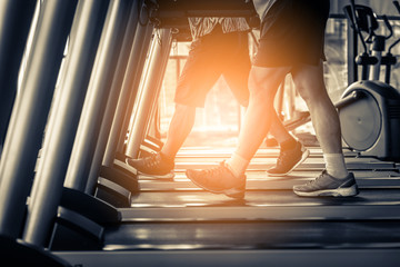 Healthy man and woman running on a treadmill at gym in the morning, The city people health lifestyle. Sport and health concept