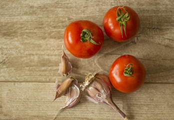 vegetables,red tomatoes and garlic on the table close-up