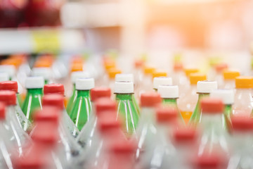 Rows of  plastic bottles cap with blur background, bad behavior of city people drinking pop.