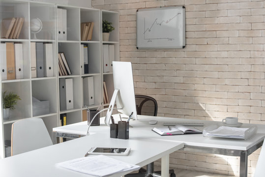 Background image of empty modern office in white color with desk and computer on it