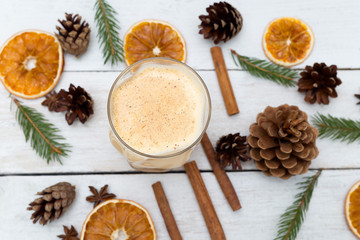 Fototapeta na wymiar Homemade eggnog with cinnamon on wooden table. Christmas drinks