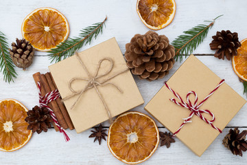 Two gift boxes on a wooden background and Christmas decorations. Flat lay