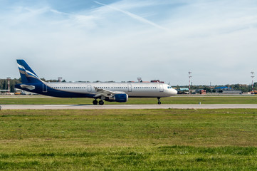 Fototapeta premium The plane was about to take off on the runway on the background of blue sky with Cirrus clouds. the horizontal frame.